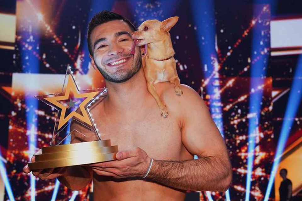 Illinois State alum Christian Stoinev and his dog Percy smilling after winning Germany's Das Supertalent.