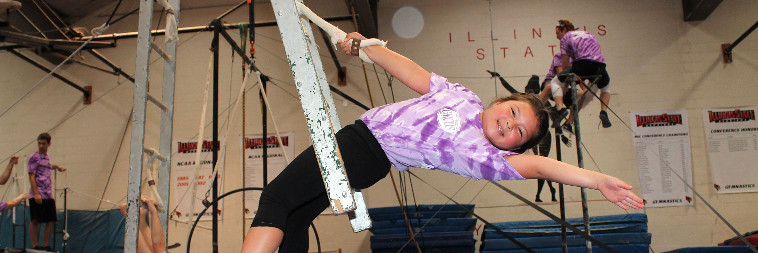 Little girl on a flying trapeze.